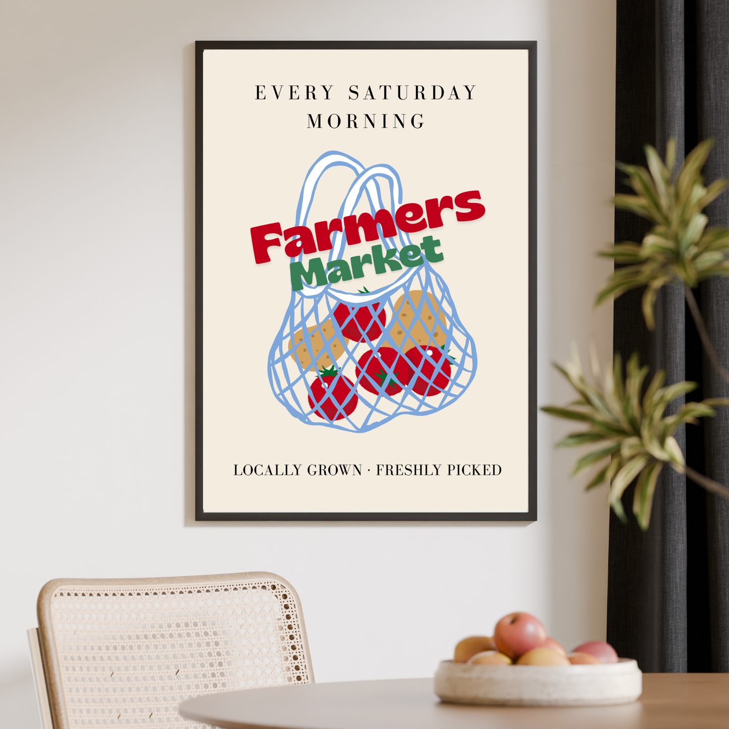 Framed poster with 'Farmers Market' design on a wall above a table with fruit.