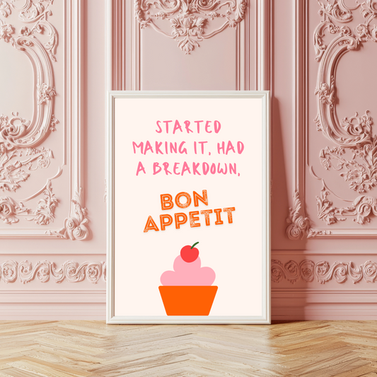 Framed print with 'Bon Appetit' text and cupcake illustration on a decorative wall.