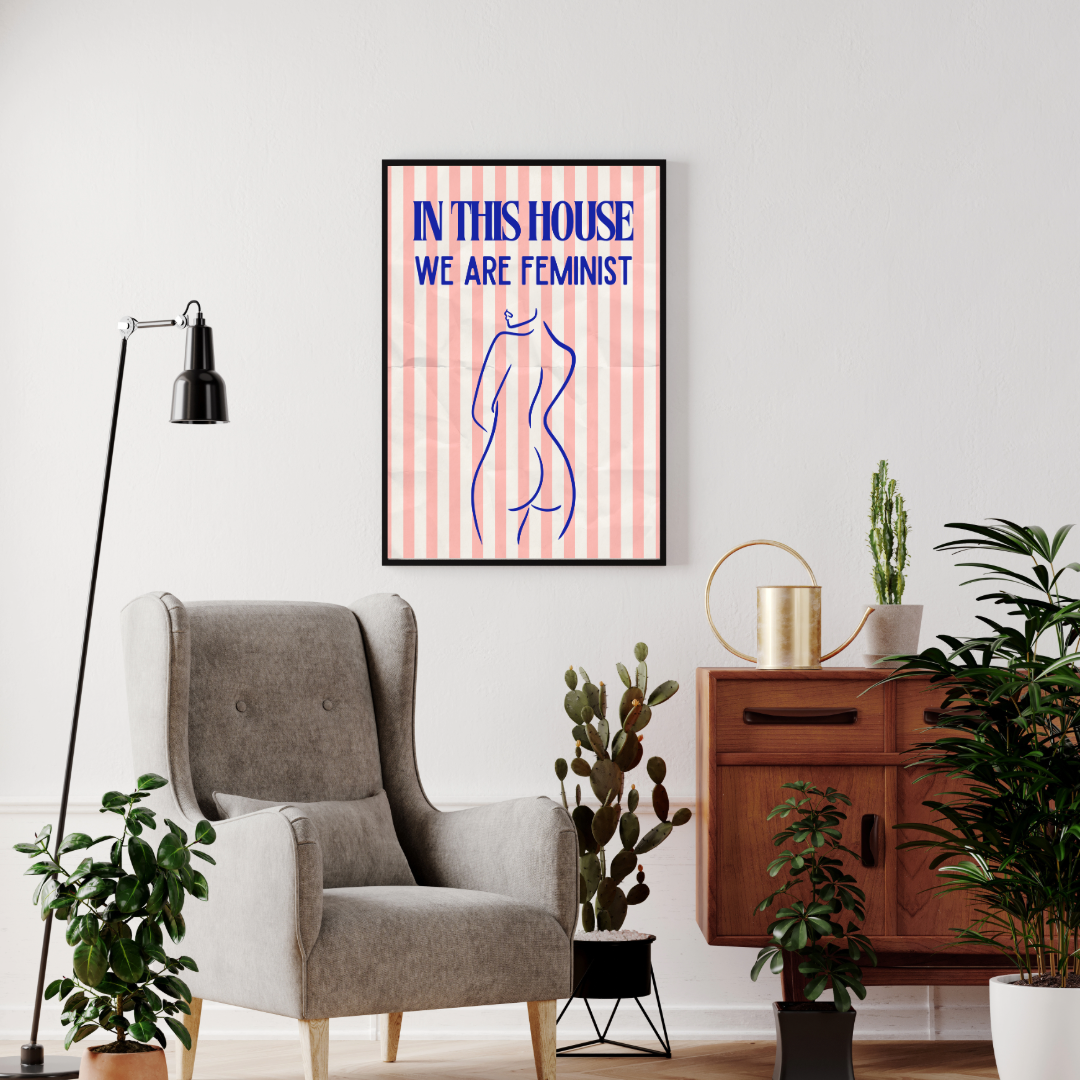 Living room with a gray armchair, plants, and a framed poster on the wall.