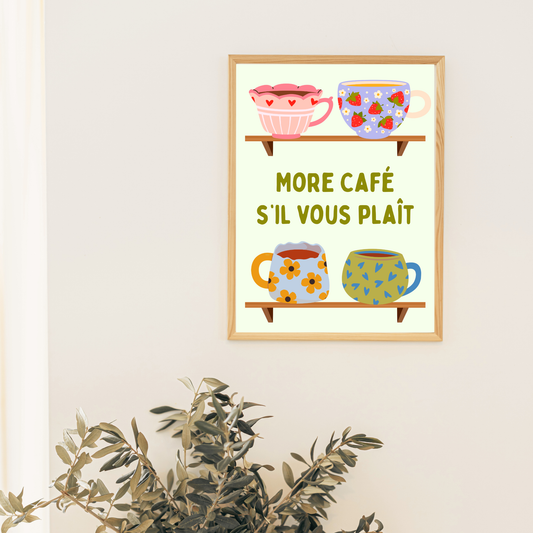Framed artwork with colorful mugs and text 'More Café S'il Vous Plait' on a white wall.
