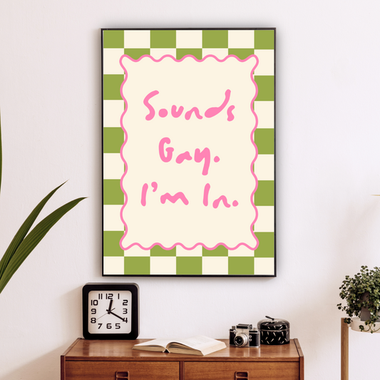 Framed artwork with text on a wall above a wooden cabinet with decorative items.