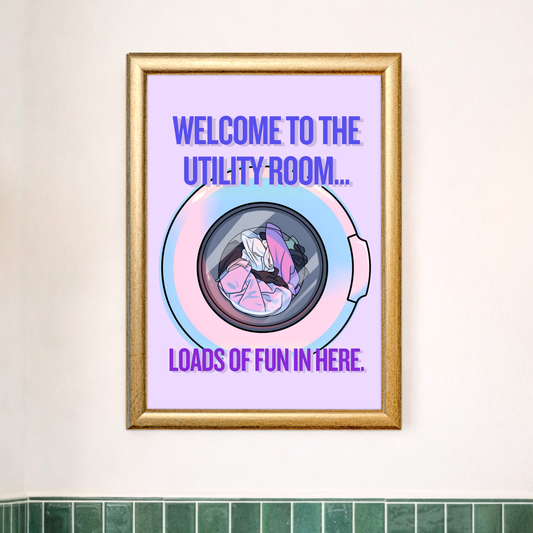 Funny utility room wall print in situ - coloured pastel purple with bold blue typography and a retro washing machine illustration - laundry room home décor gift idea