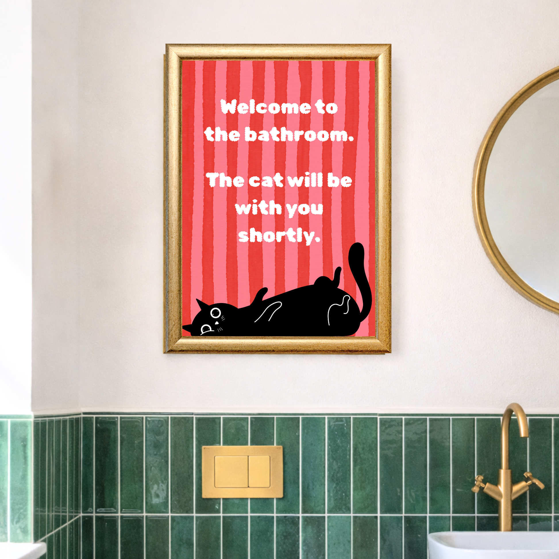 Cat bathroom print displayed above green tiles in modern bathroom with gold mirror and brass fixtures
