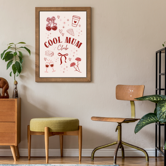 Framed “Cool Mum Club” art print with red illustrations including cherries, coffee cup, pizza slice, books, wine glasses, and flowers in a frame on the wall, with modern decor and interiors.