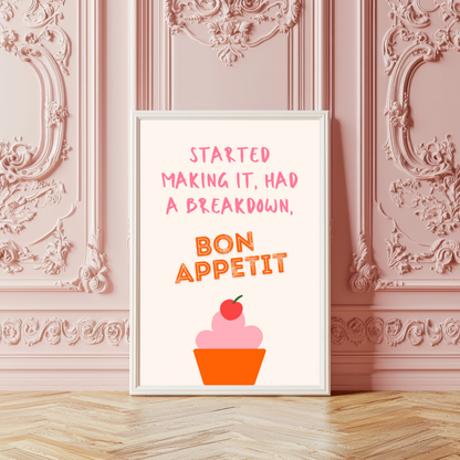 Framed print with 'Bon Appetit' text and cupcake illustration on a decorative wall.