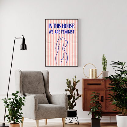 Living room with a gray armchair, plants, and a framed poster on the wall.