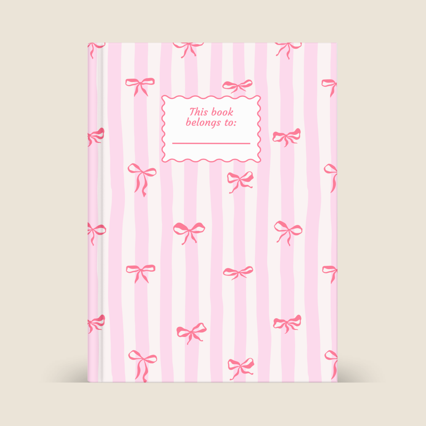 Book with pink stripes and bows on a beige background