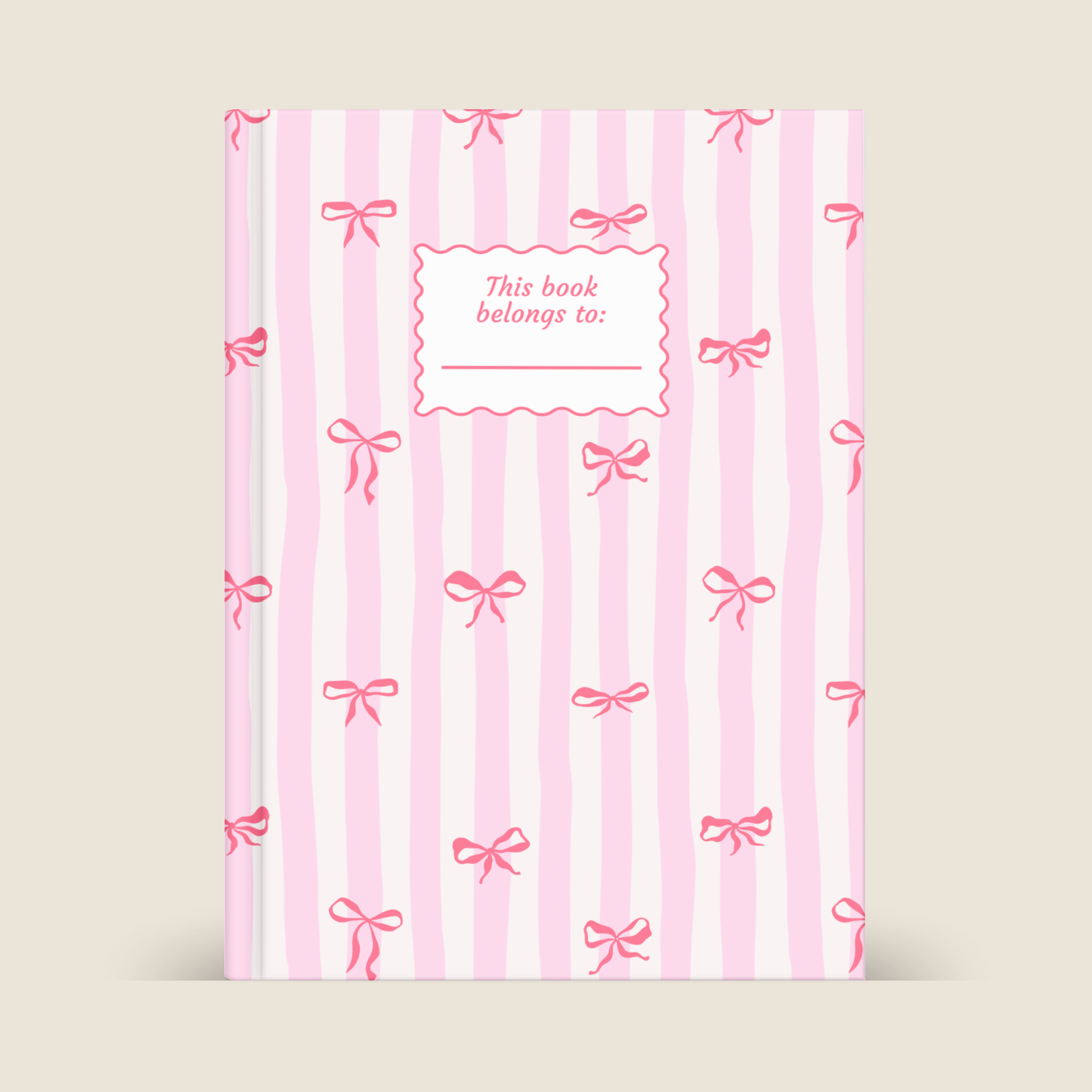 Book with pink stripes and bows on a beige background