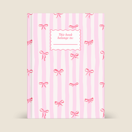 Book with pink stripes and bows on a beige background